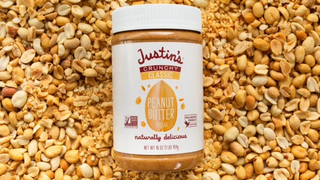 Justin’s is launching Classic Crunchy Peanut Butter, Peanut Caramel Nougat Chocolate Candy Bars, and Frozen Pocket Sandwiches.