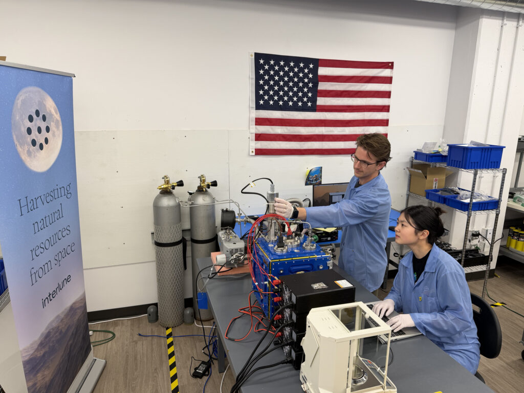 Interlune test engineer Alex Lewandowski and mechanical engineer Jessica Wu check mass spectrometer test equipment in Seattle as NASA’s $6.9 million award pushes lunar helium-3 extraction closer to its first commercial test.