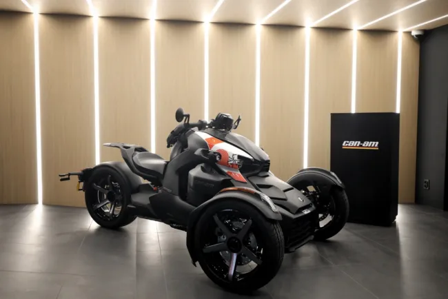 The Can-Am three-wheel motorcycle featured at BRP’s Paris flagship store, showcasing the brand’s urban EV mobility strategy