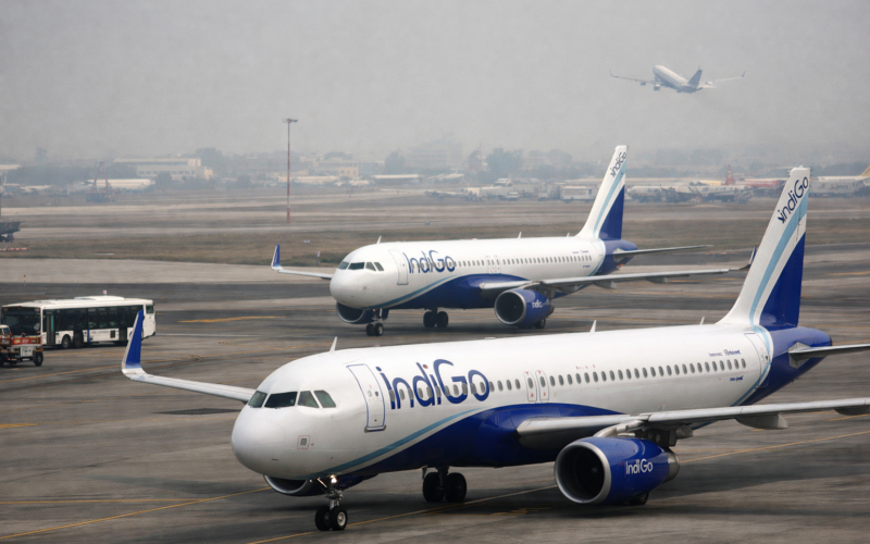 Representative image of grounded passenger aircraft at an Indian airport, illustrating the story on how soaring fuel costs, Gulf airspace disruption, and Directorate General of Civil Aviation schedule cuts are worsening the summer 2026 crisis for Indian airlines.