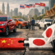 Representative image of Chinese and Japanese passenger vehicles in a Southeast Asian urban market, illustrating how BYD Co. Ltd., Chery Automobile Co. Ltd., and SAIC Motor Corp. Ltd. are challenging Japanese automaker dominance across the ASEAN light vehicle market amid rising electric vehicle and hybrid demand.
