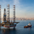 Representative image of an offshore jack-up drilling rig and support vessel in Gulf waters, reflecting ADNOC Drilling’s record Q1 2026 performance, strong rig utilisation, integrated oilfield services growth, and expanding regional energy platform.