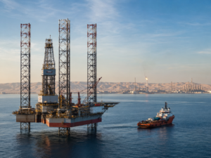 Representative image of an offshore jack-up drilling rig and support vessel in Gulf waters, reflecting ADNOC Drilling’s record Q1 2026 performance, strong rig utilisation, integrated oilfield services growth, and expanding regional energy platform.