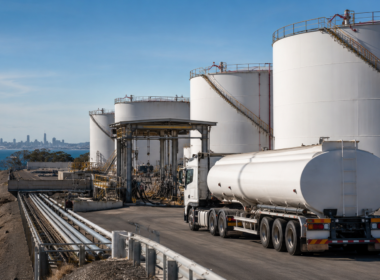 Representative image showing fuel storage tanks and tanker logistics, as Australia’s petrol and diesel reserve release highlights growing energy security risks and supply chain pressure.
