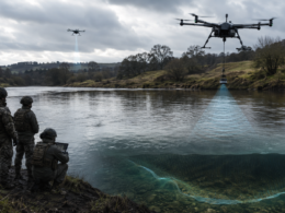 Representative image: Drone-deployed wet gap sensors survey a river crossing from a safe stand-off distance, illustrating how UK Defence Innovation’s Map the Gap Phase 3 competition could help the British Army reduce risk for Royal Engineer reconnaissance teams during opposed water crossings.