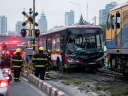 Representative image of emergency responders at an urban railway crossing after a train-bus collision, illustrating the deadly Thailand crash near Bangkok’s Makkasan area that killed eight people and injured dozens.
