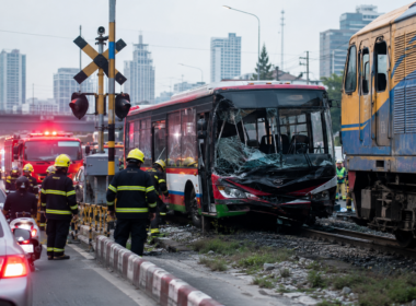 Representative image of emergency responders at an urban railway crossing after a train-bus collision, illustrating the deadly Thailand crash near Bangkok’s Makkasan area that killed eight people and injured dozens.