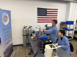 Interlune test engineer Alex Lewandowski and mechanical engineer Jessica Wu check mass spectrometer test equipment in Seattle as NASA’s $6.9 million award pushes lunar helium-3 extraction closer to its first commercial test.