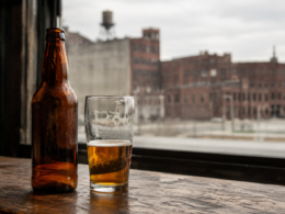 Representative image: A quiet bar scene with an unbranded beer bottle and half-filled glass evokes the fading legacy of Schlitz Premium, as Pabst Brewing Company places the historic Milwaukee beer brand on hiatus amid changing U.S. beer market economics.