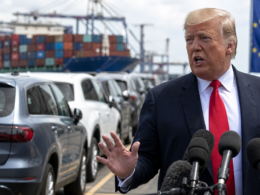 Representative image of United States President Donald Trump addressing reporters as imported cars and shipping containers frame the renewed United States–European Union auto tariff dispute, after Washington threatened to raise tariffs on European Union cars and trucks to 25 per cent.