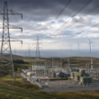 Representative image of electricity transmission infrastructure, a modern power substation and wind turbines, illustrating SSE plc’s £33 billion investment plan to expand UK energy networks and support long-term grid growth after its FY2026 preliminary results.