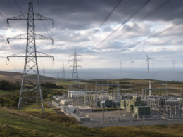 Representative image of electricity transmission infrastructure, a modern power substation and wind turbines, illustrating SSE plc’s £33 billion investment plan to expand UK energy networks and support long-term grid growth after its FY2026 preliminary results.