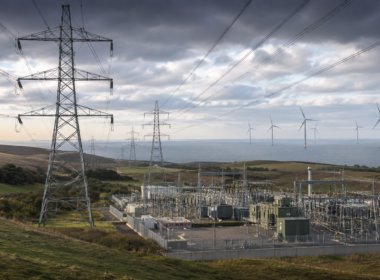 Representative image of electricity transmission infrastructure, a modern power substation and wind turbines, illustrating SSE plc’s £33 billion investment plan to expand UK energy networks and support long-term grid growth after its FY2026 preliminary results.