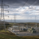 Representative image of electricity transmission infrastructure, a modern power substation and wind turbines, illustrating SSE plc’s £33 billion investment plan to expand UK energy networks and support long-term grid growth after its FY2026 preliminary results.