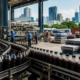Representative image of an unbranded beverage bottling plant with packaged soft drinks, illustrating Coca-Cola’s India IPO plans and the growth of India’s FMCG beverage sector.