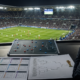 Representative image of a football analyst reviewing tournament brackets and tactical plans inside a packed stadium, highlighting how the FIFA World Cup 2026 format expands to 48 teams, 12 groups and a new round of 32.
