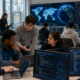 Representative image: University students collaborate on AI software projects in a modern technology lab, reflecting IBM’s global AI Builders Challenge and the expansion of IBM Bob access to 20,000 post-secondary institutions worldwide.
