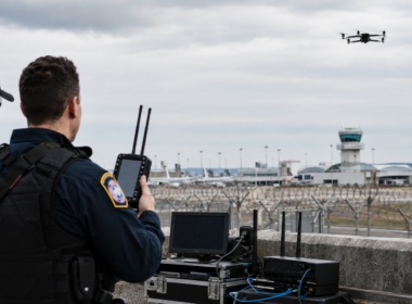 Representative image of drone surveillance near an airport security perimeter, illustrating Motorola Solutions’ D-Fend Solutions acquisition and the growing counter-drone security market.