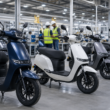 Representative image of unbranded electric scooters in a factory, illustrating Ola Electric’s QIP fundraise and India’s fast-growing EV two-wheeler market.