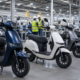 Representative image of unbranded electric scooters in a factory, illustrating Ola Electric’s QIP fundraise and India’s fast-growing EV two-wheeler market.