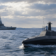 Representative image: An autonomous naval drone operating alongside a warship reflects Safran’s proposed €2.24 billion acquisition of Exail Technologies and the growing strategic value of maritime robotics in European defense.