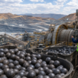 Representative image of grinding media, mining equipment and workers at an industrial processing site, illustrating Tega Industries’ Molycop acquisition and global mining consumables expansion.