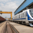 Representative image of a rail manufacturing yard with modern passenger coaches and freight wagons, illustrating Titagarh Rail Systems’ Q4 FY26 execution challenge as investors track its order book, Vande Bharat pipeline and railway manufacturing growth outlook.