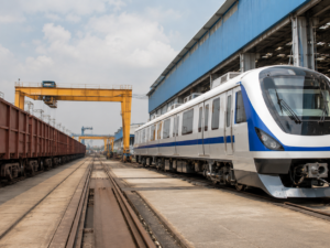 Representative image of a rail manufacturing yard with modern passenger coaches and freight wagons, illustrating Titagarh Rail Systems’ Q4 FY26 execution challenge as investors track its order book, Vande Bharat pipeline and railway manufacturing growth outlook.
