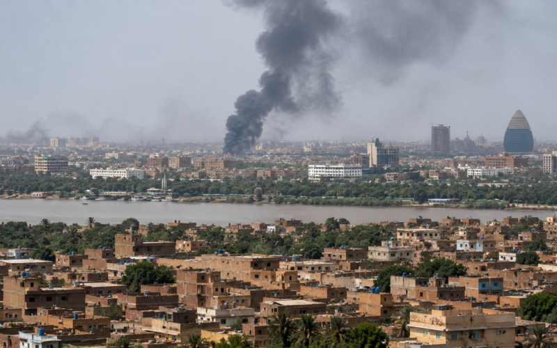 Representative image of smoke rising over a Sudanese city as the army-led government demands a full Rapid Support Forces withdrawal before accepting the United States peace proposal.