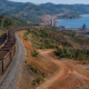 Representative image of an iron ore train and coastal export port, illustrating how Guinea’s Simandou Iron Ore Project is ramping up its 120Mtpa mine, rail and port system for global steel markets.