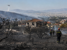 Representative image: Firefighters inspect scorched hillsides and damaged homes near Athens after Greece contained major wildfires that forced evacuations and exposed growing climate and infrastructure risks.
