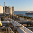 A coastal LNG terminal and export tanker illustrate the domestic gas supply debate behind Australia’s redesigned Domestic Gas Reservation Scheme, which could require LNG exporters to reserve up to 20% of gas output to help ease projected market shortfalls. Representative image.