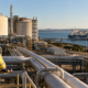 A coastal LNG terminal and export tanker illustrate the domestic gas supply debate behind Australia’s redesigned Domestic Gas Reservation Scheme, which could require LNG exporters to reserve up to 20% of gas output to help ease projected market shortfalls. Representative image.