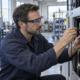 A technician wearing generic augmented-reality glasses illustrates the hands-free industrial applications targeted by Snap’s enterprise initiative. Representative image.